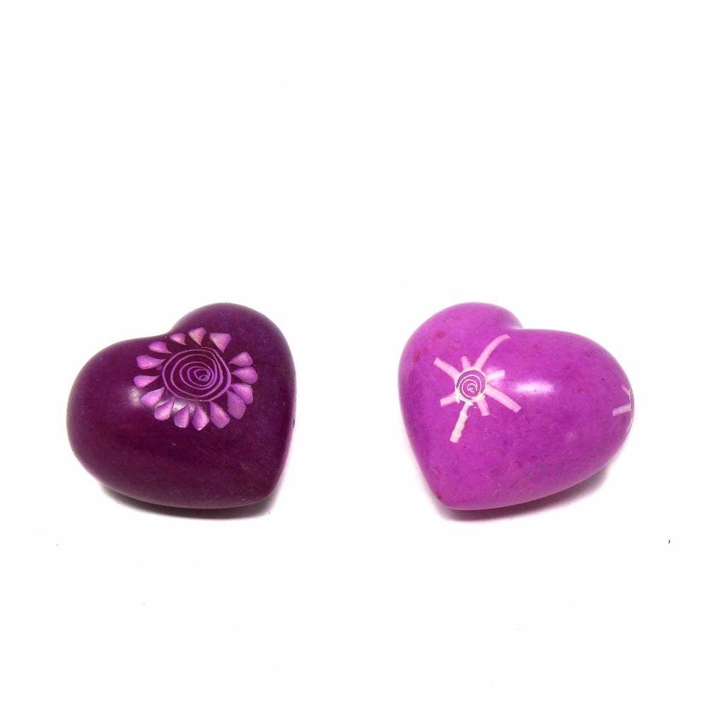 Two purple heart-shaped objects with white designs on a white background