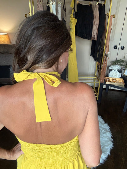 Person wearing a yellow dress with a blurred background
