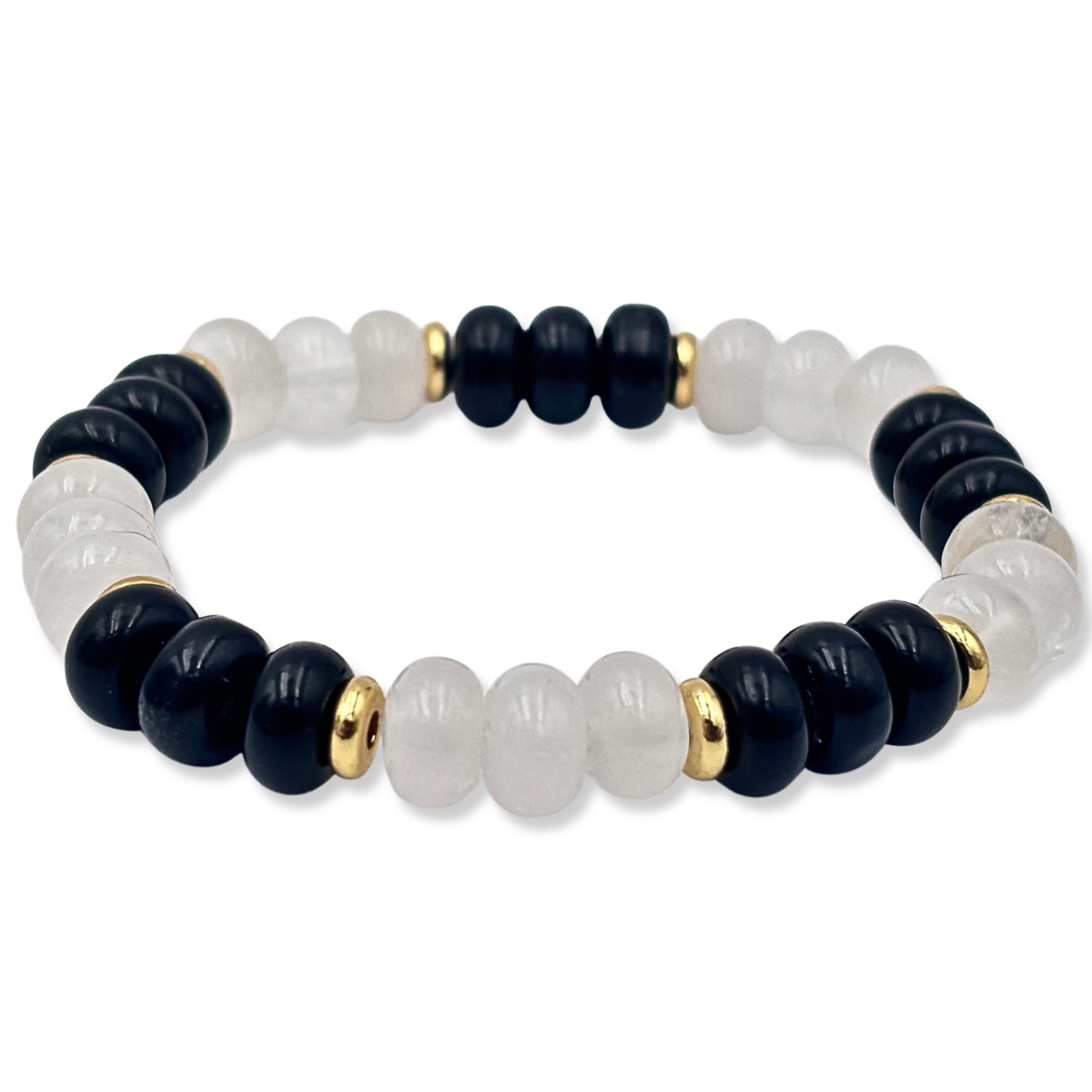 A beaded stretch bracelet featuring alternating matte black and polished white beads, accented by small gold spacer beads, shown on a plain white background.