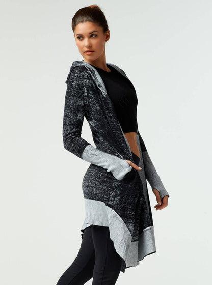 Woman wearing a gray and black patterned cardigan on a white background