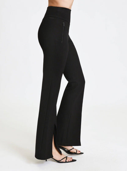 Black flared pants worn by a person on a white background