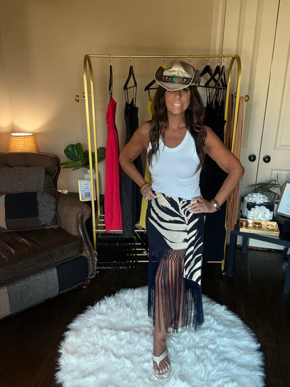 Woman posing in a room with a clothing rack and decor