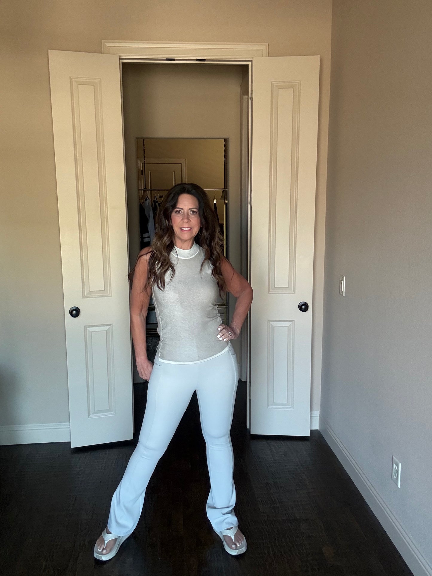 Woman standing in a room with open doors