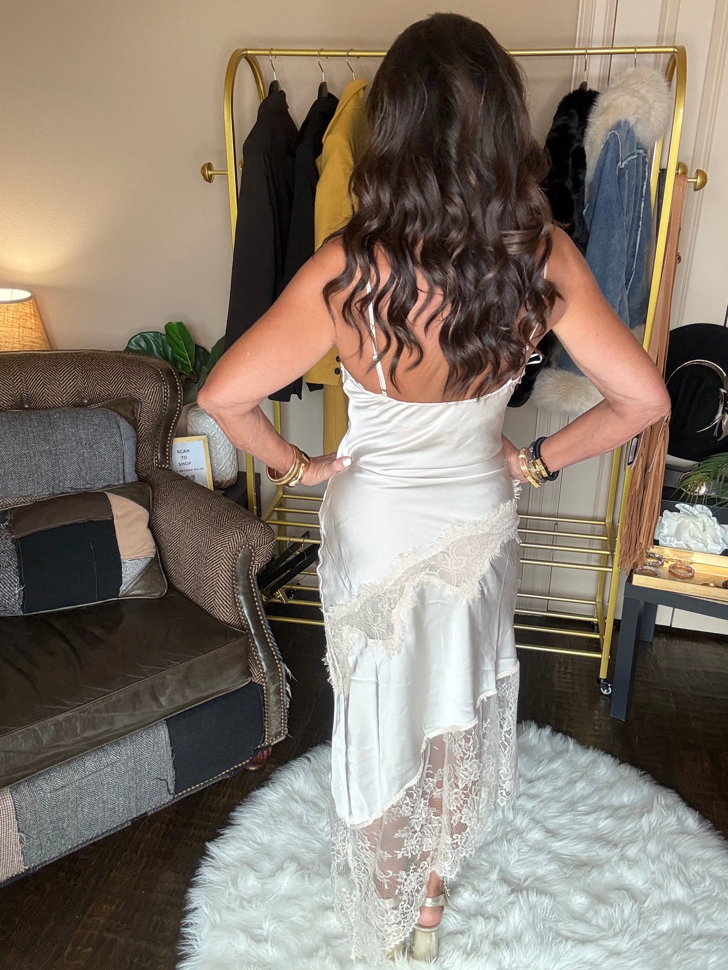 Back view of the pearl satin lace trim maxi dress showing the low back, thin straps and asymmetrical lace skirt.
