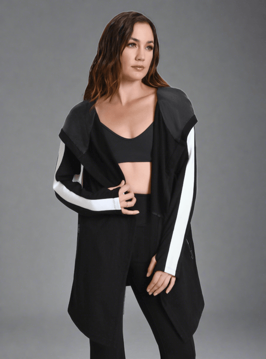 Woman wearing a black outfit with white stripes on a gray background