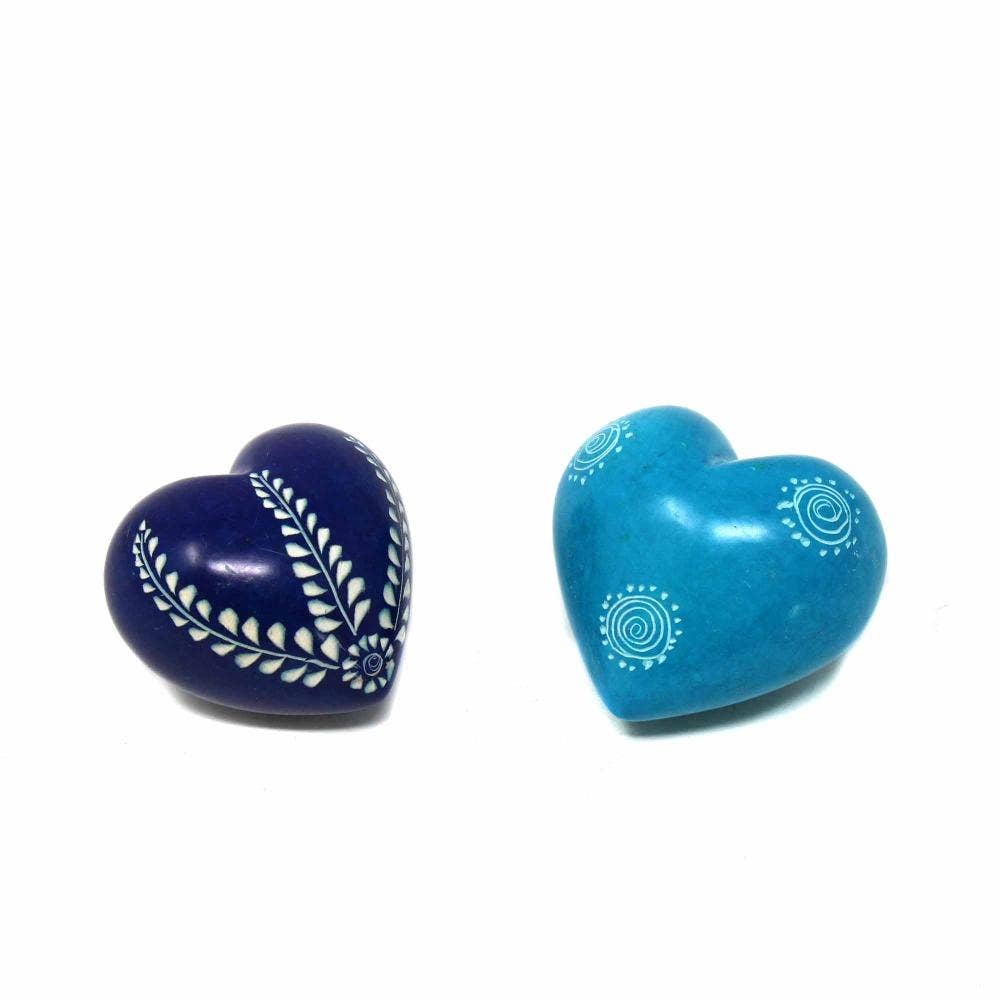 Two heart-shaped objects, one blue and one purple, with white designs on a white background.
