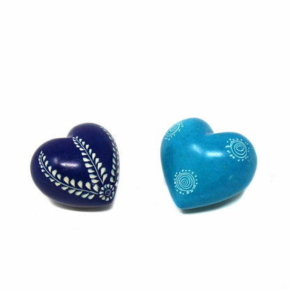 Two heart-shaped objects, one blue and one purple, with white designs on a white background.